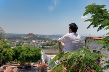 Canvas Print - Young man at El Pueblito pyramid Quetaro Mexico archaeological zone Mayan ruins Hispanic town