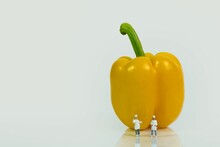 Cooks In Front Of A Yellow Raw Bell Pepper