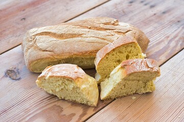 Sticker - wheat bread, traditional village bread, kneaded by hand, on a wooden table