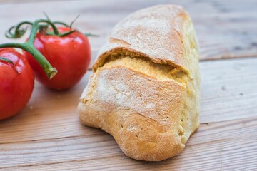 Sticker - wheat bread, traditional village bread, kneaded by hand, on a wooden table