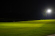 Beautiful dark night view of the golf course, Bunkers sand and green grass, garden background In the light of the spotlight underexposure view. Film camera look photo noise and Grain.