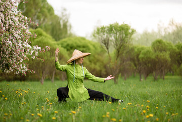 Asian woman train with tai chi in the park in the evening, chinese martial arts, healthy life care concept.