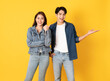 © stnazkul - Two Young good looking asian couple using isolated on yellow background presenting to copy space