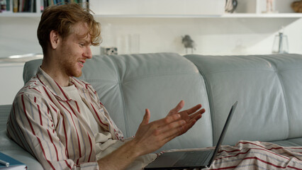 Happy guy talking virtual meeting at home closeup. Man enjoy video conference