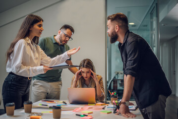 Stressed business colleagues having a meeting in an office and solving problems