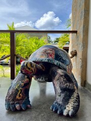 Wall Mural - Vertical shot of local artwork ,handmade wooden giant turtle ,Seychelles