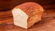 Closeup of a fresh loaf of bread on the wooden surface.