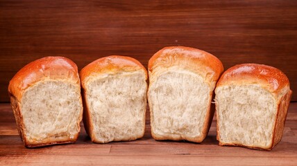 Poster - Closeup of fresh loaves of bread on the wooden surface.