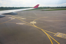 Airport yellow taxiway lines markings on the apron on concrete asphalt, sign for airplane pilots.