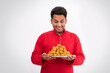 © Prkash Pictures - happy Indian man looking and holding plate full of laddoos, with excitement