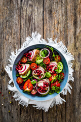 Canvas Print - Tasty salad - roast pork loin, cucumber, cherry tomatoes, pomegranate, strawberries and fresh, green vegetables on wooden table
