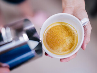 espresso coffee in the hands  preparing for latte art