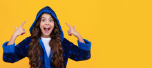 Excited Child In Hooded Bathrobe Happy Screaming Pointing Fingers Yellow Background, Point. Child Face, Horizontal Poster, Teenager Girl Isolated Portrait, Banner With Copy Space.