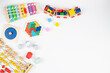 © vejaa - Baby kids colorful educational and musical toys on white background. Top view, flat lay frame