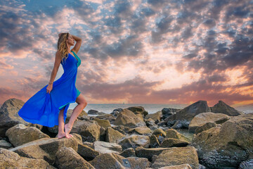 Wall Mural - Lovely Brunette Latin Model Poses Outdoors On A Beach At Sunset