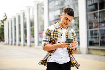 Wall Mural - Student uses phone near university