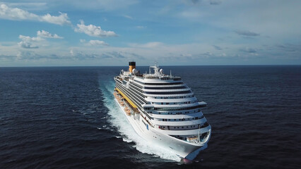 Side view of modern ocean liner in open sea, luxury vacation concept. Stock. Aerial of picturesque seascape with a cruise ship sailing across the sea.