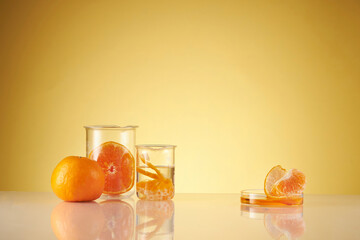 Wall Mural - Front view of orange decorated with glassware and transparent podium in brown background