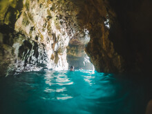 Woman Swimming With Snorkeling Mask In Sea Grotto Cave