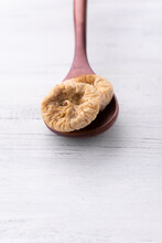 Brown Wooden Spoon With Dried Figs On White Background For Catalog