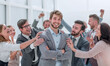 © ASDF - close up. cheerful company employees applauding their colleague.