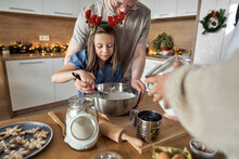 Smiling Man With Daughter Mixing Cookie Dough In Kitchen
