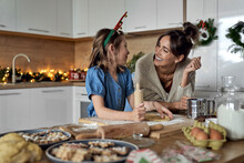 Happy Woman And Daughter Enjoying Baking Time In Kitchen
