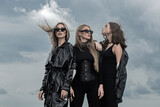 Stylish Sexy Black Clothes. Fashion Portrait Of Group Fashion Models Girls  Posing Outdoor, Black Style Outfit Against Sky. Attractive Young Vogue Women.  Stock Photo, Picture and Royalty Free Image. Image 195261573.