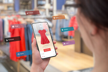 Wall Mural - shopping with smart phone and augmented reality app in the boutique concept. trying on the latest cl