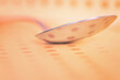 Metallic spoon. Close up of a dotted background reflected on the surface of a spoon with a shallow depth of field.