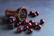 Ripe cherry, coal and ceramic bowl with tobacco for hookah on the grey background