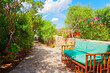 Outdoor green garden beach patio wooden bench in backyard porch of home with nobody in Sardinia tropical house 