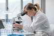 © StockPhotoPro - Professional scientist using a microscope