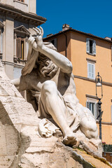 Sticker - Close-up on ancient marble statue decorating a fountain in Rome showing a man covering his head