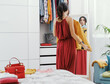 © StockPhotoPro - Woman choosing clothes in her bedroom