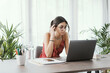 © StockPhotoPro - Student sitting at desk and working with a laptop