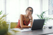 © StockPhotoPro - Woman sitting at desk and thinking