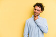 © Asier - Young caucasian man isolated on yellow background touching back of head, thinking and making a choice.