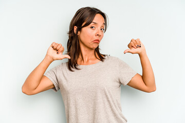 Young hispanic woman isolated on blue background joyful and carefree showing a peace symbol with fingers.