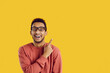 Happy excited cheerful ethnic black college or university student smiling and doing pointing gesture at cool solution, good idea, useful contact phone number on text copyspace background on right side