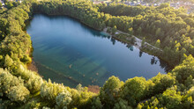 Blue Lakes From Above. Lakes In Green Forest In Evening Sunlight Aerial Drone View. Scenic Summer Background. Picturesque Lakeside With Forest. High Quality Photo