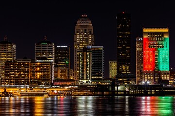 Wall Mural - Aerial cityscape of Louisville surrounded by tall buildings near water in night