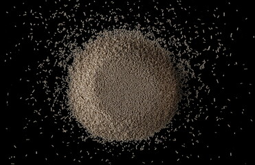 Wall Mural - Active dry yeast granules pile isolated on black, top view 