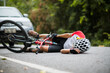 © VStudio - An Asian mountain biker was hit by a car on the road. A mountain biker was injured in a collision with a car on the road. Concept reduces accidents from using cars on the road. Selective focus.