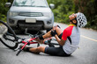 © VStudio - An Asian mountain biker was hit by a car on the road. A mountain biker was injured in a collision with a car on the road. Concept reduces accidents from using cars on the road. Selective focus.