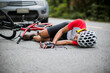 © VStudio - An Asian mountain biker was hit by a car on the road. A mountain biker was injured in a collision with a car on the road. Concept reduces accidents from using cars on the road. Selective focus.
