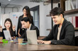 © SKW - Asian businessman looking at the camera Working and meeting at the office at the company with colleagues at the back
