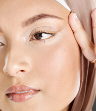 Face Of A Beautiful Muslim Woman Wearing A Brown Headscarf And Lifting The Skin Around Her Eyes. Headshot Of Hijab Lady Contemplating Eyelift Surgery For A More Youthful And Wrinkle Free Appearance