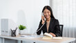 Business woman is receiving call with client to talking about investment of new business and checking information