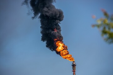 Power tower burning in the daytime.